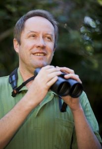 Image of Professor Hugh Possingham with binoculars